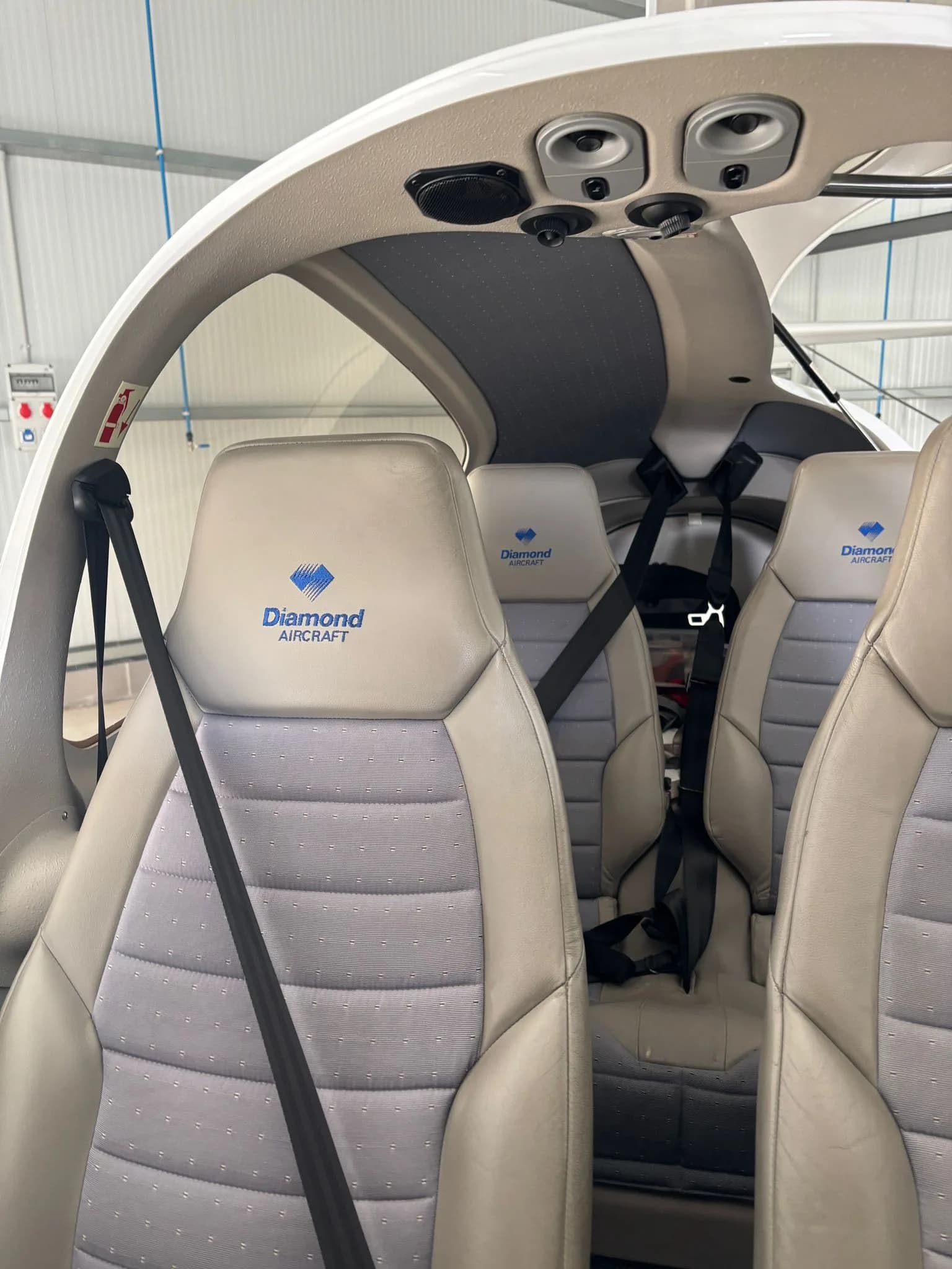 Front seats of a Diamond DA40 aircraft with Diamond Aircraft logo on the headrests.