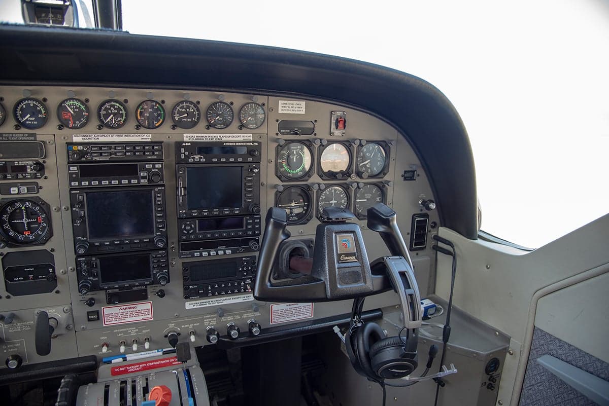 View of the aircraft cockpit instrument panel and seats.