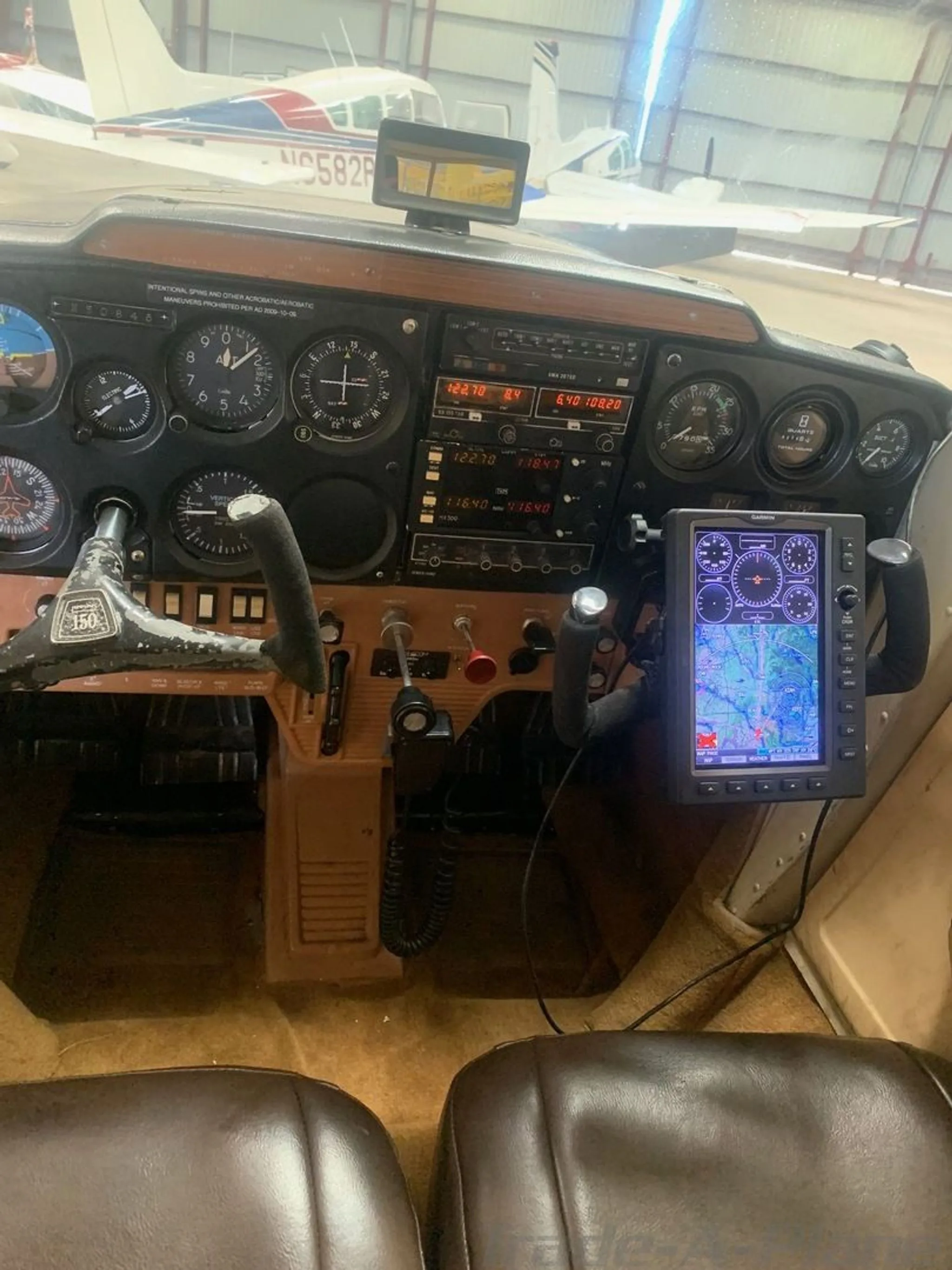 The instrument panel and controls of the aircraft, featuring a modern GPS display.