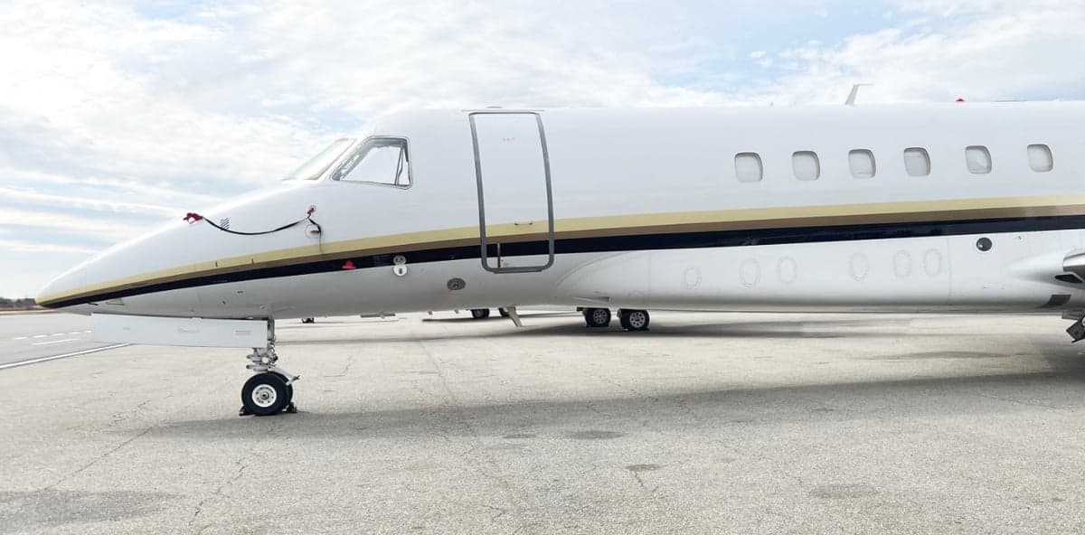 Close-up of the nose and front landing gear of a Challenger aircraft.