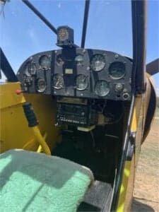 Close up of the instrument panel of a yellow Cubcrafters aircraft.