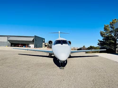 Front view of a white Cessna Citation on the tarmac.