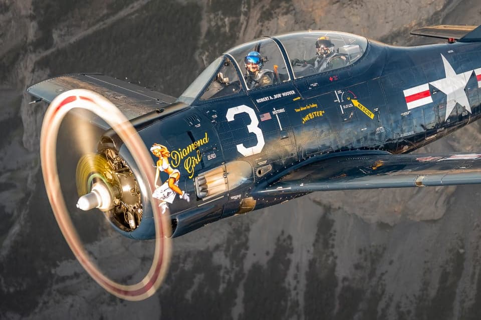 HB-RMW T-28B Trojan flying in the clouds.