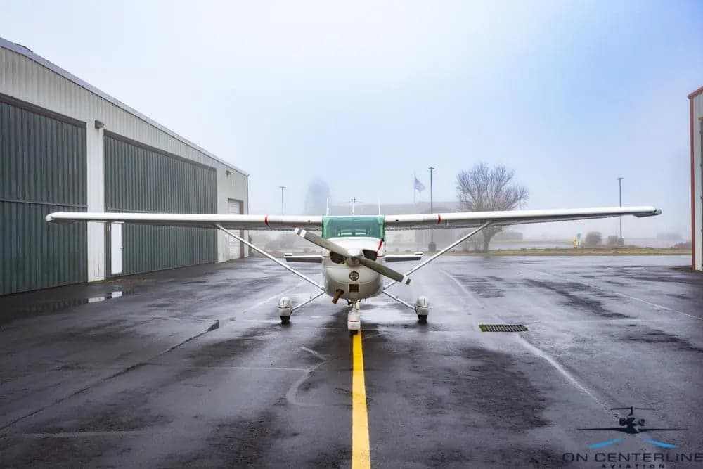 Front view of a Cessna 172 Skyhawk parked on the tarmac.