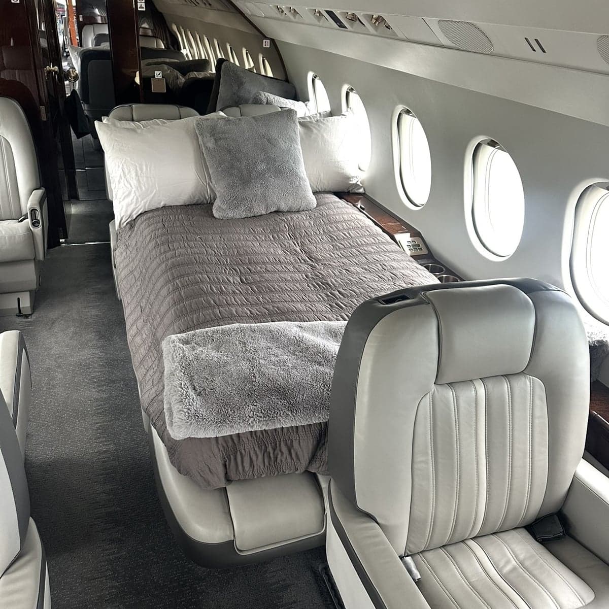 View of the aircraft interior with a bed made up.