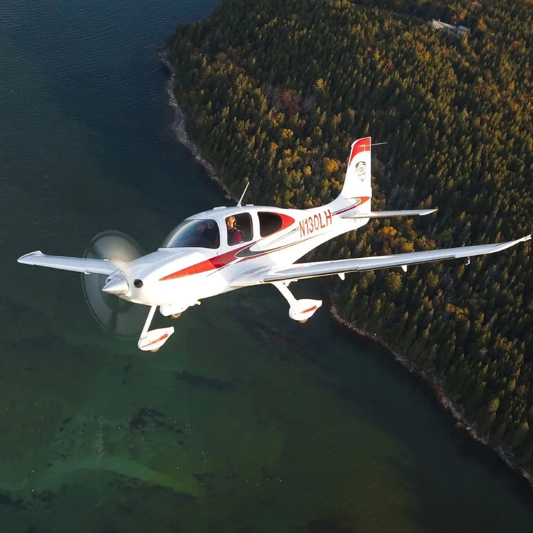 Cirrus SR22 in flight over the ocean.