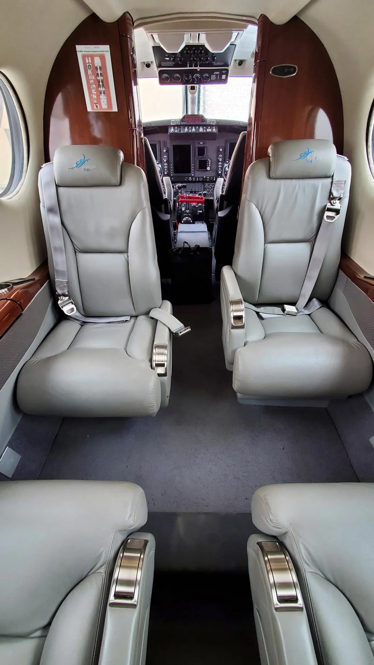 Overhead view of the aircraft's cabin seating arrangement with a view of the cockpit.