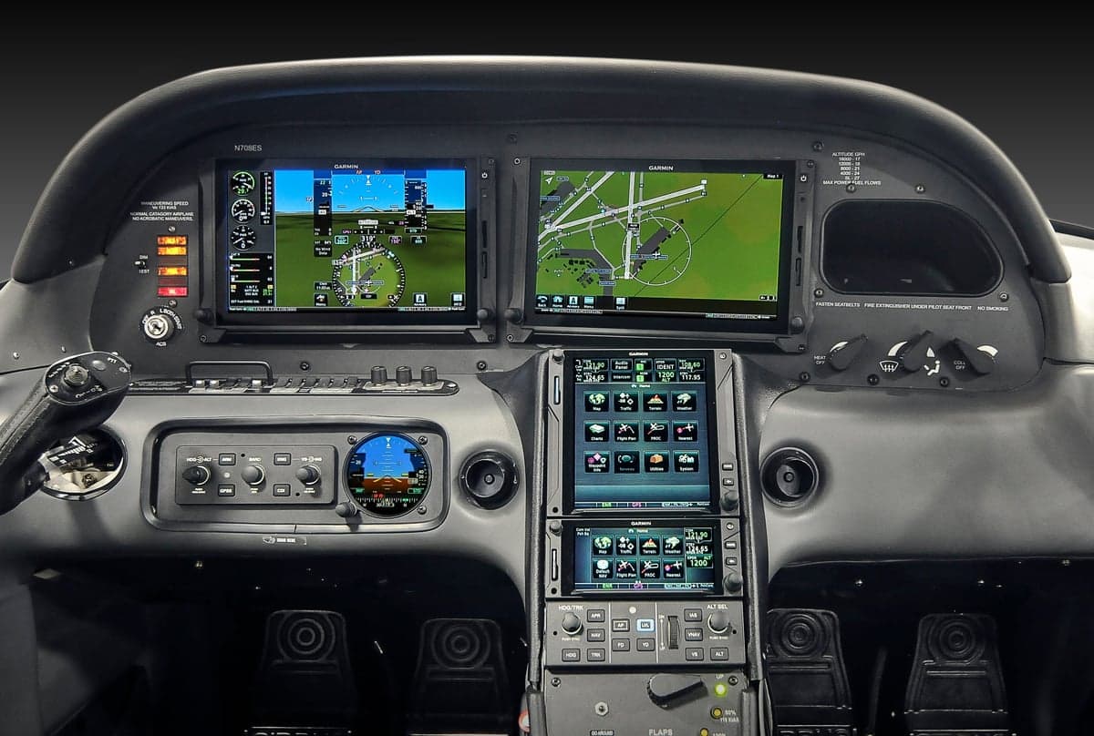 The instrument panel of a Cirrus aircraft features dual Garmin displays.