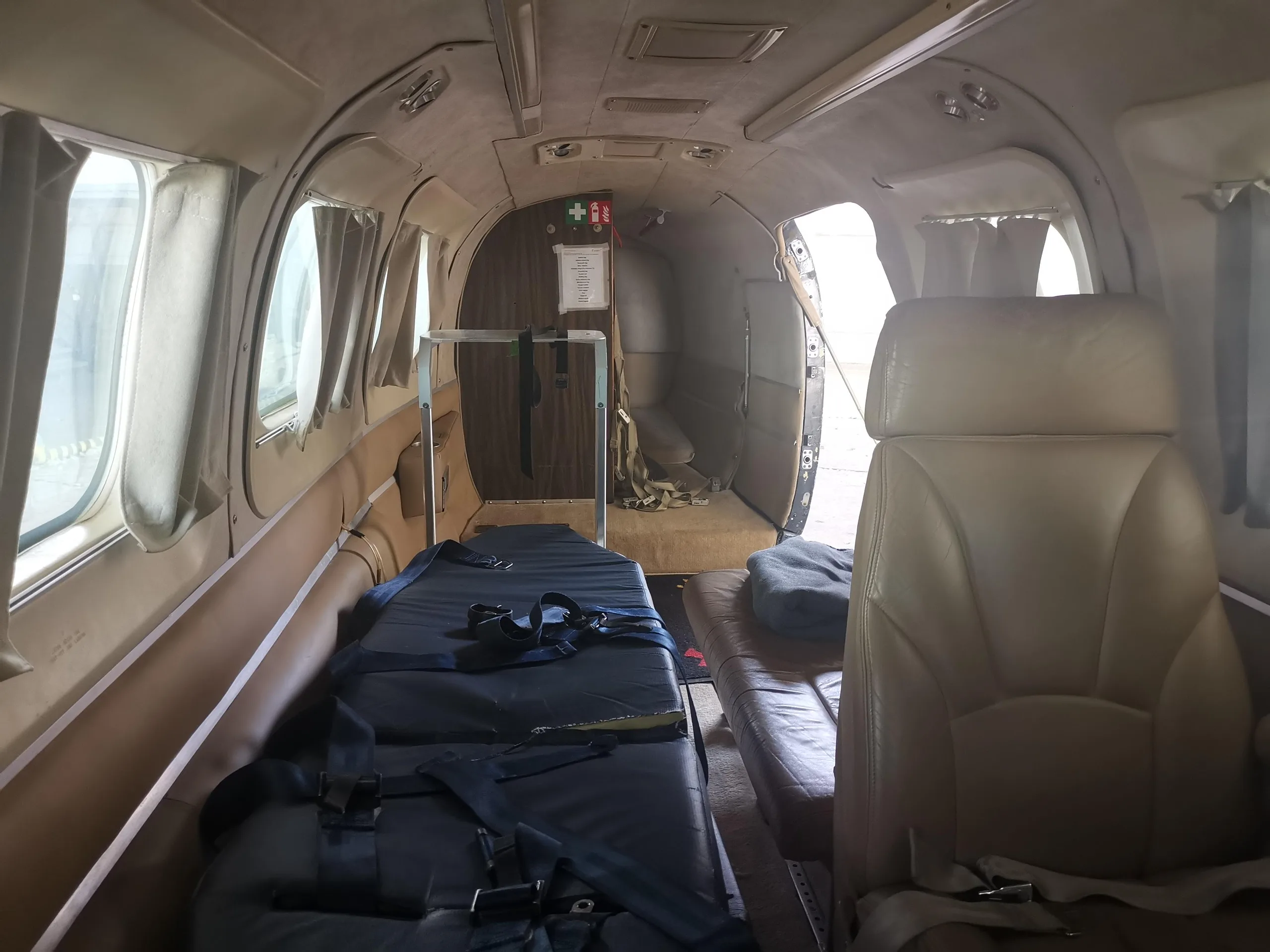 Interior view of the aircraft cabin with medical equipment and seats.