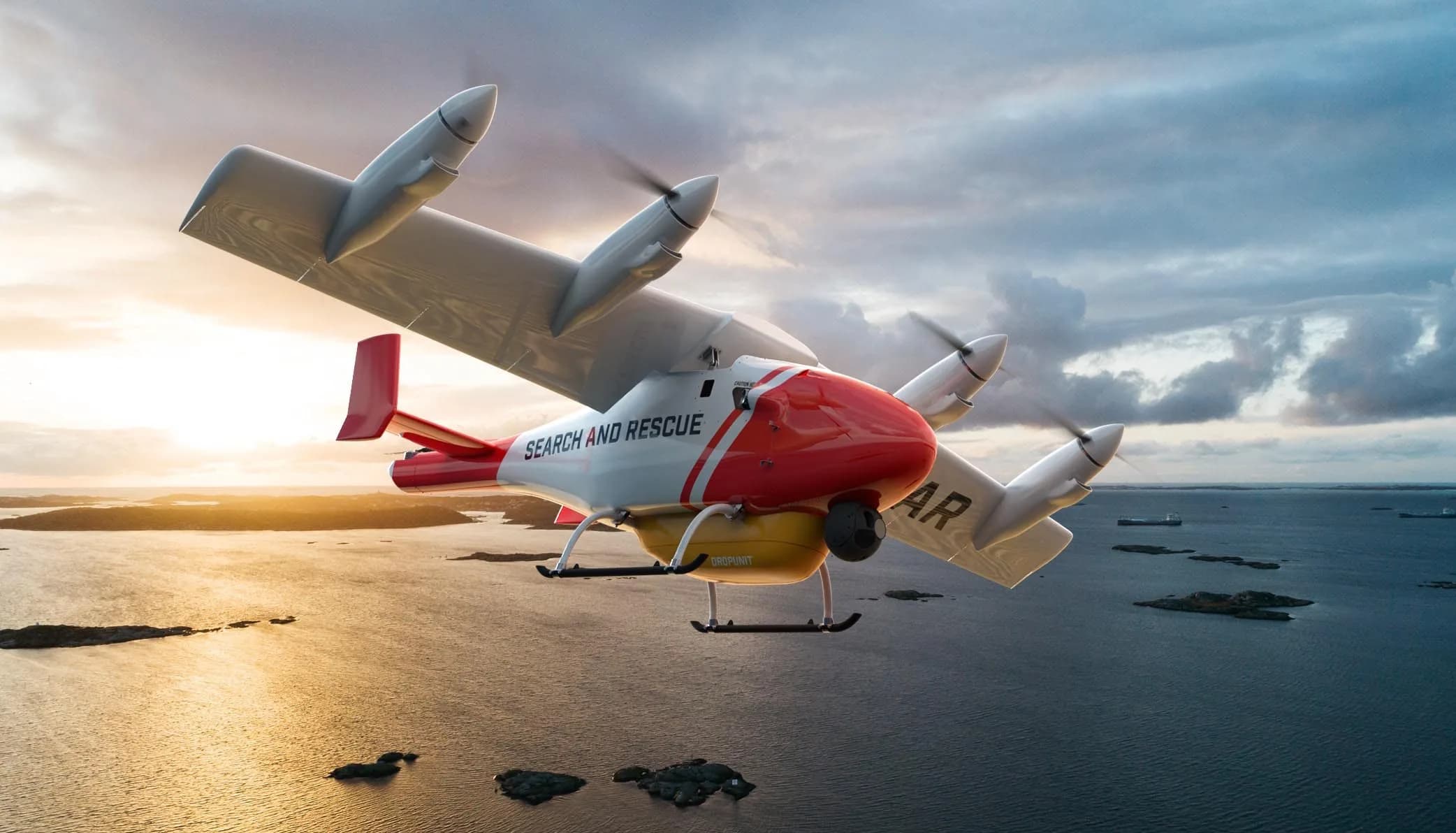 A red and white search and rescue eVTOL aircraft flying over a body of water with islands at sunset.