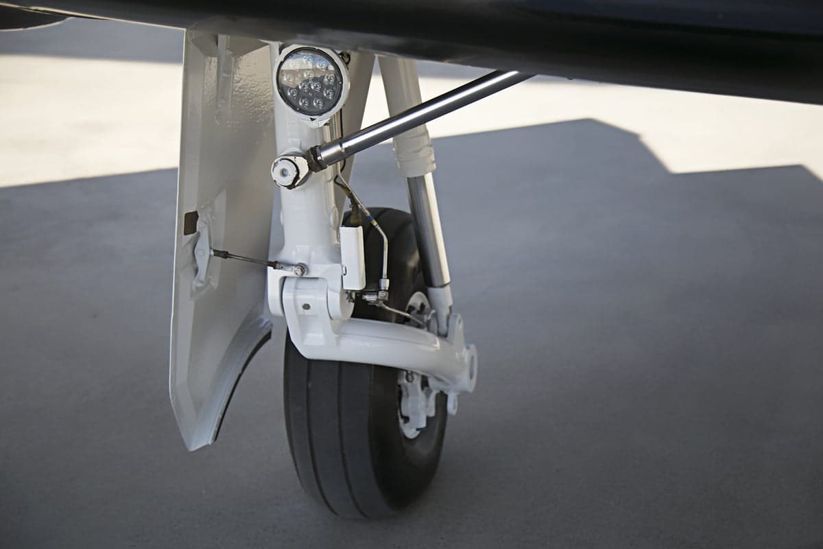 Close-up of the landing gear of the Pilatus PC-12 aircraft.