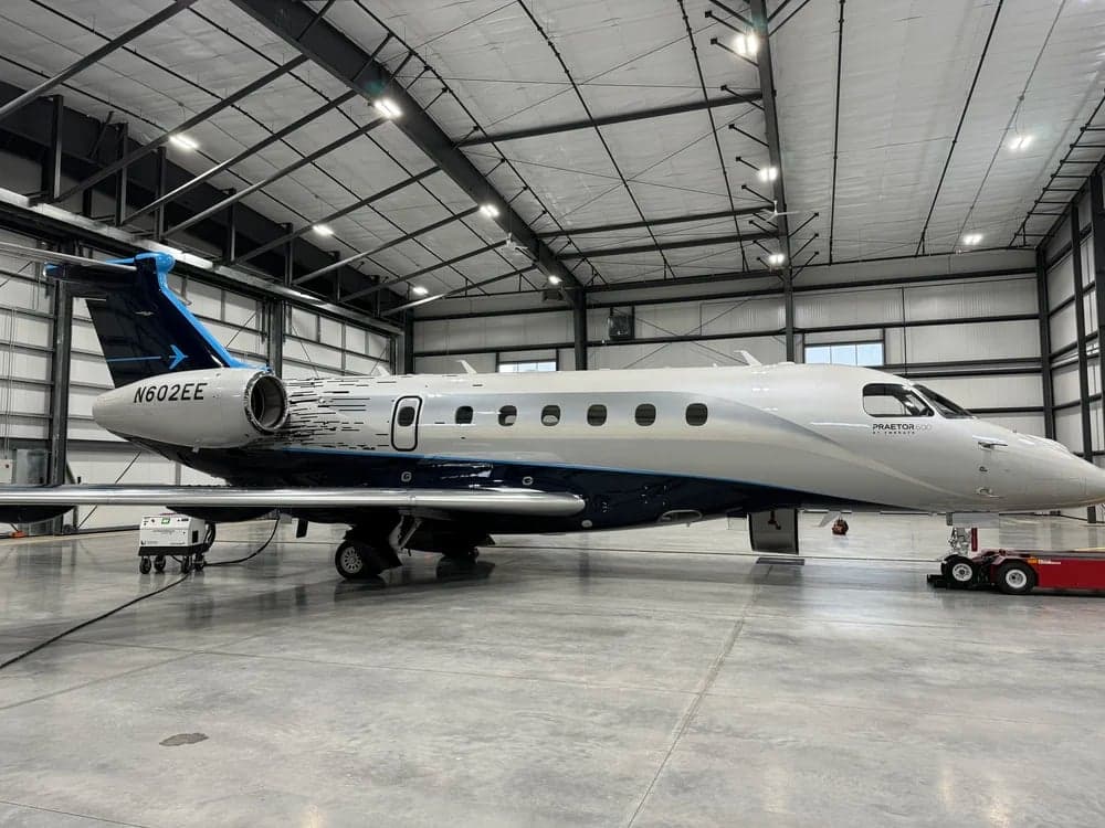 N602EE Praetor 600 aircraft in a hangar, side view.