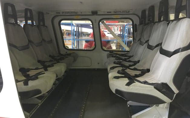 AgustaWestland AW139 helicopter in flight with red and white paint scheme.
