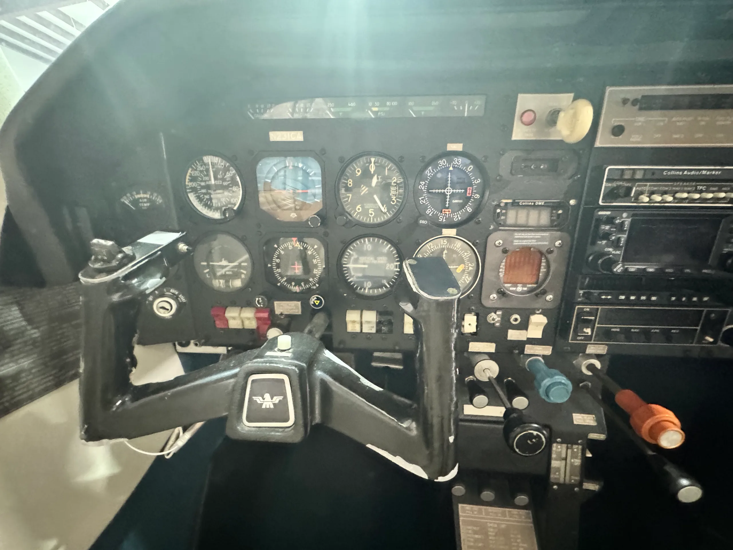 Detailed view of the aircraft's instrument panel with gauges, radios, and control yokes.