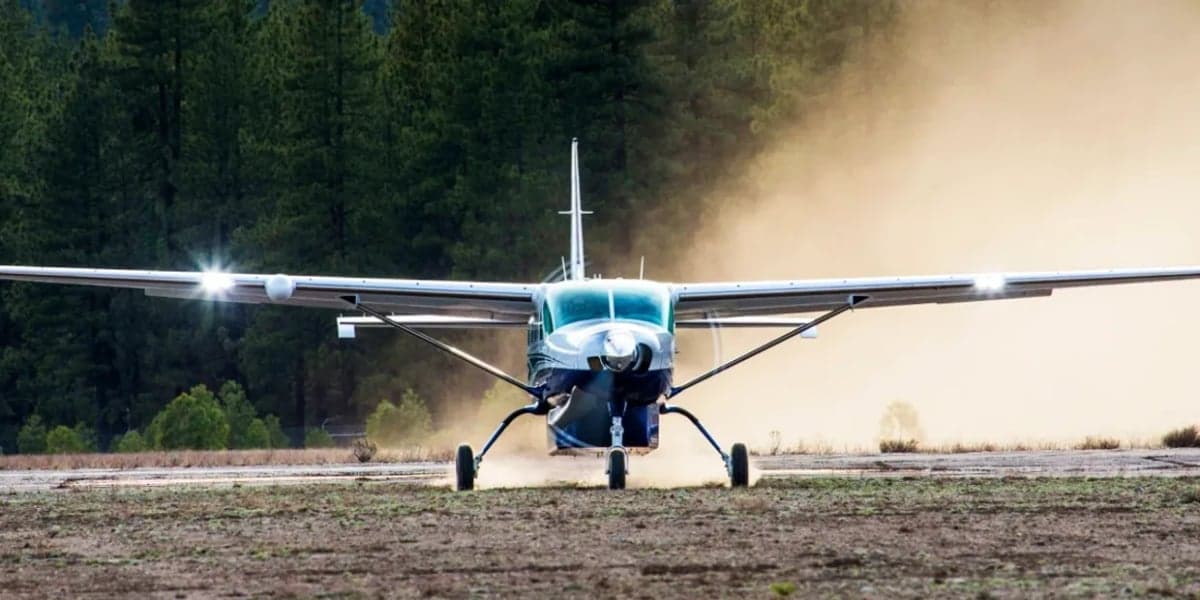 Front view of a Quest Kodiak aircraft on a dirt runway.