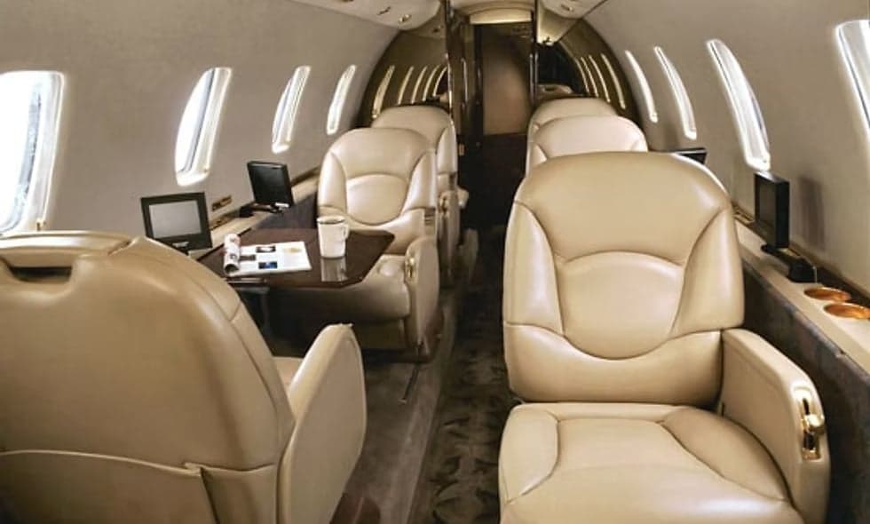 A white Cessna Citation jet is parked on the tarmac.