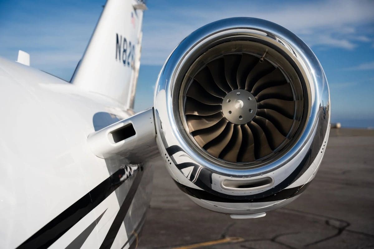 Close-up of the aircraft's engine and tail section with tail number N826LM.