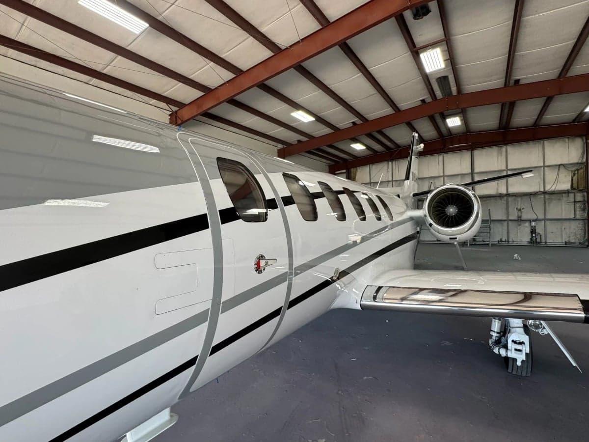 Close-up side view of a Cessna Citation CJ3, registration N858RM, inside a hangar.