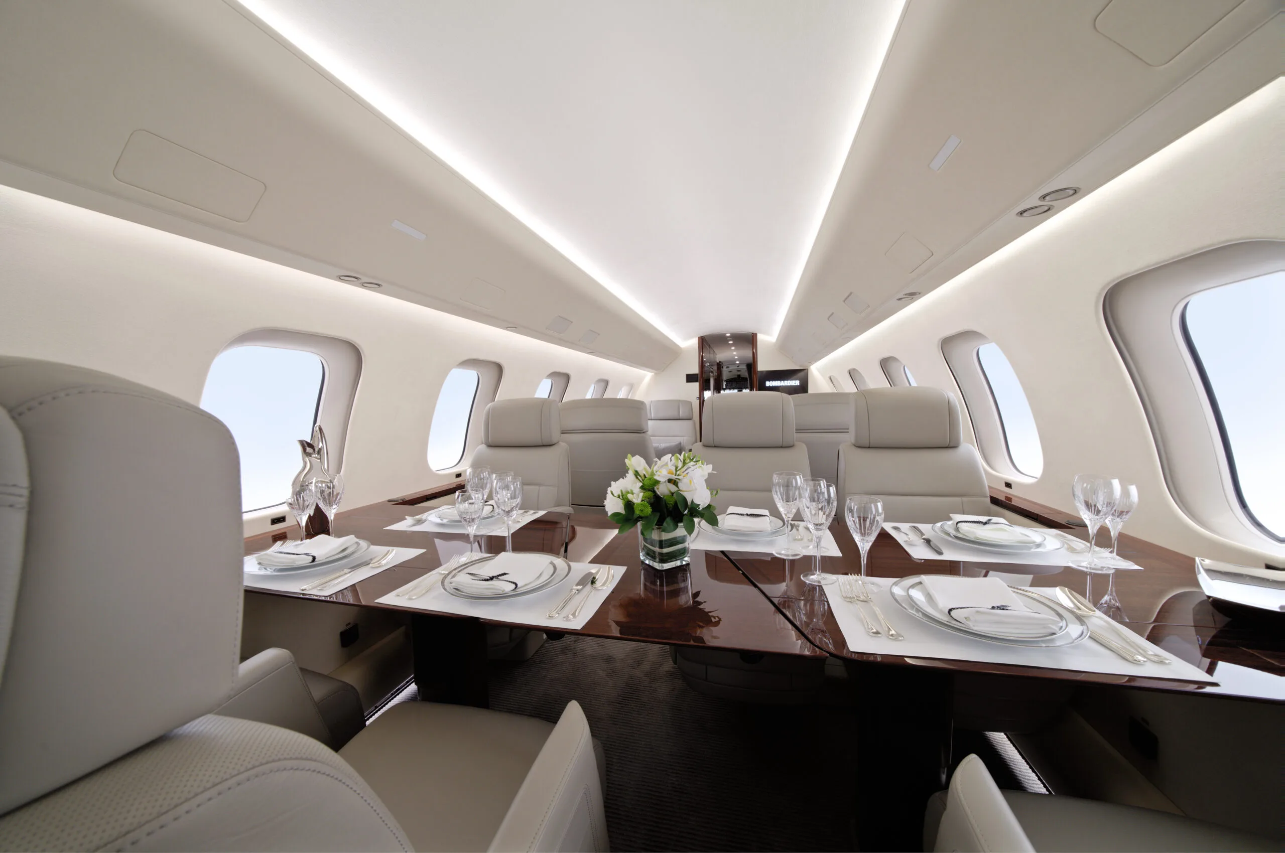 Aircraft interior with dining table and seating.