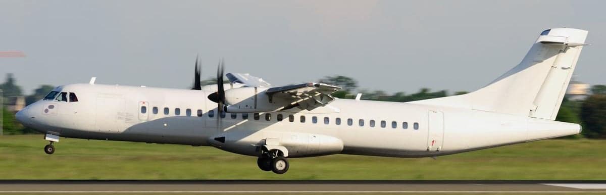An ATR 42 aircraft taking off from a runway.