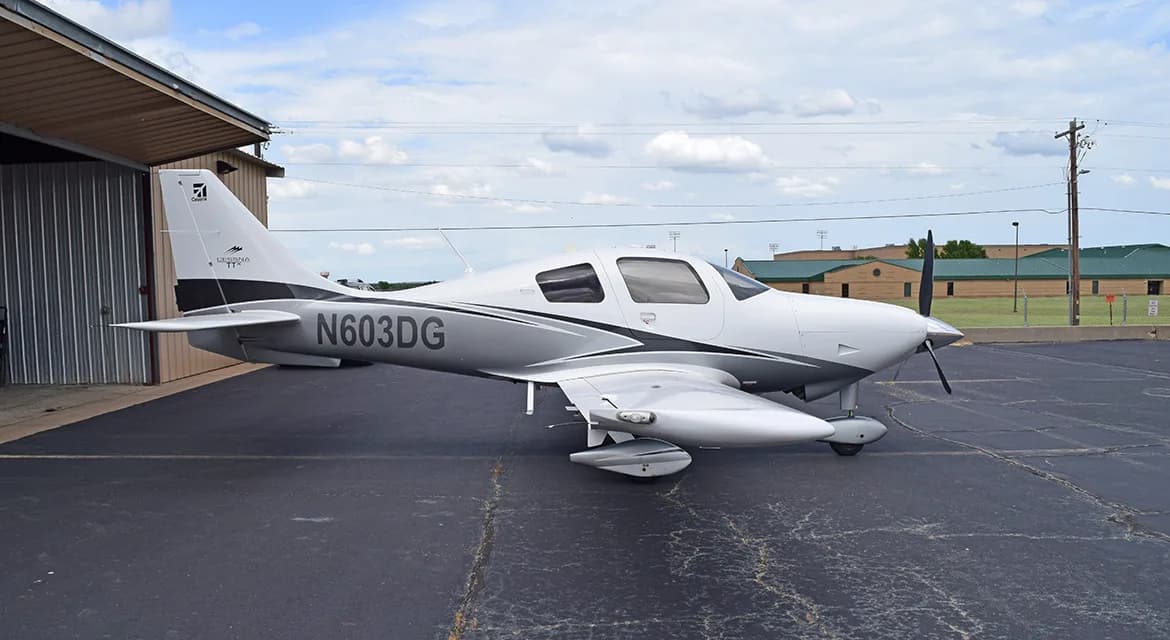 A white and grey Cessna TTx aircraft, N603DG, viewed from the front-right on an asphalt apron.
