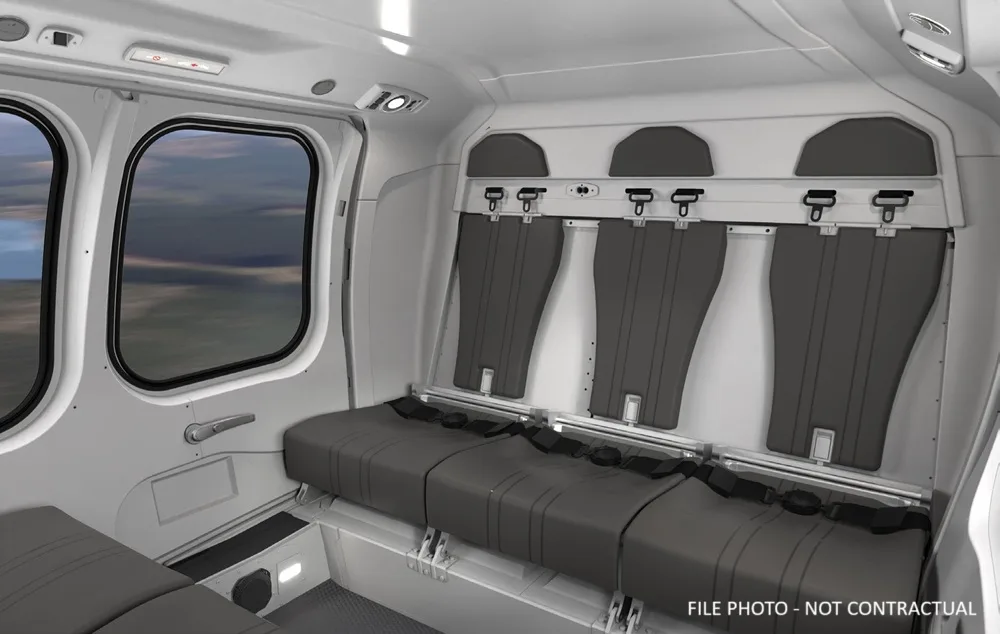 Interior view of the helicopter cabin with grey seats.