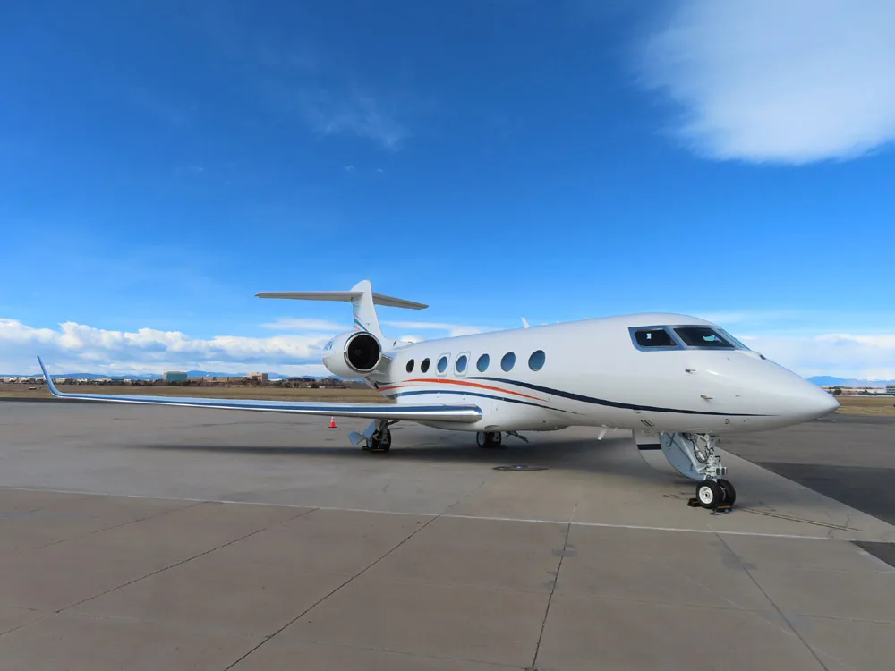A Gulfstream G500 on the tarmac with a blue sky background.