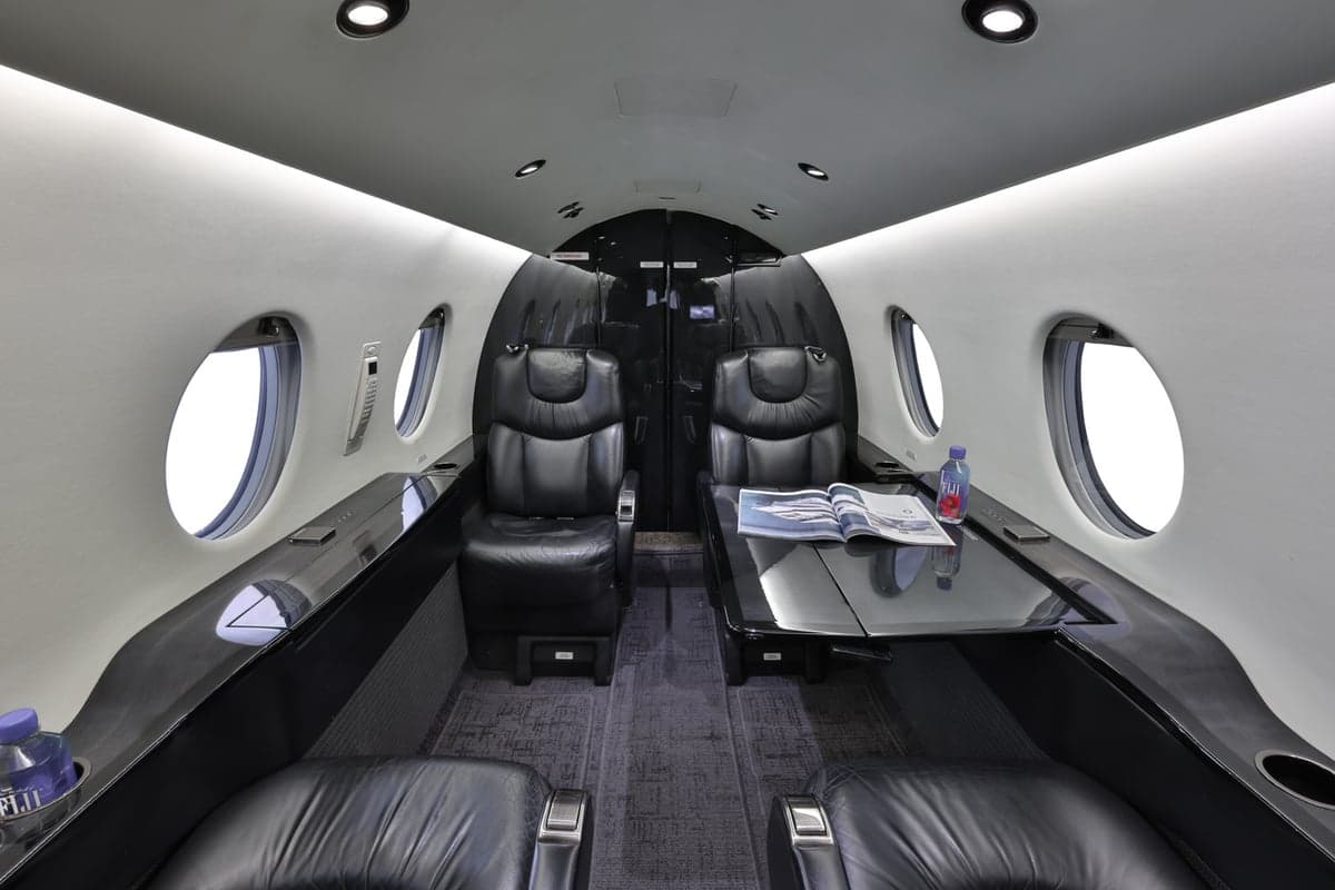 The Hawker 400XP cabin features a central table and comfortable seating.