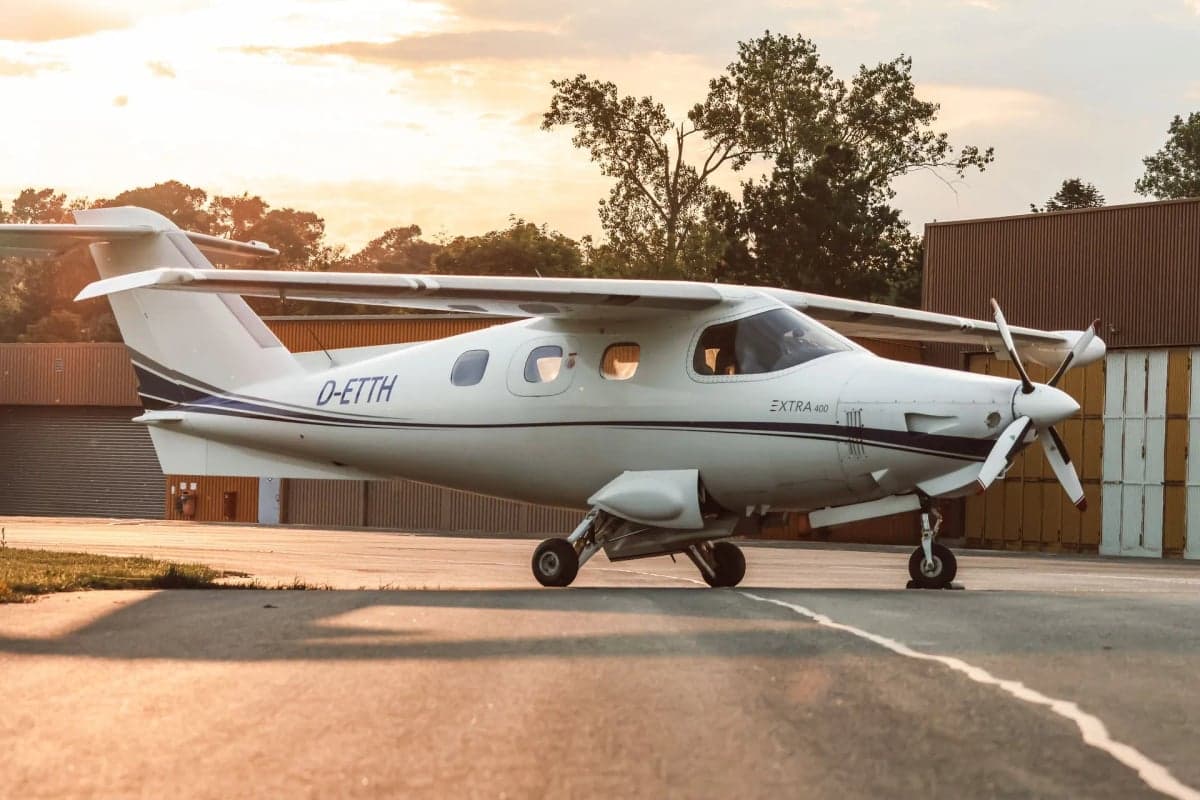 Front side view of the Extra 400 aircraft D-ETTH on the ground.