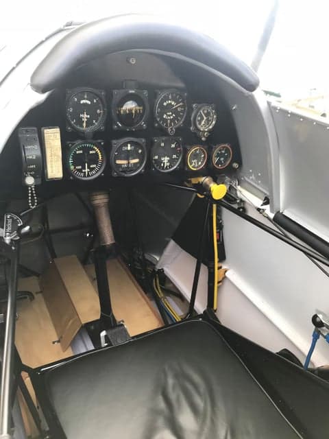 Close-up of the biplane aircraft's cockpit and engine.