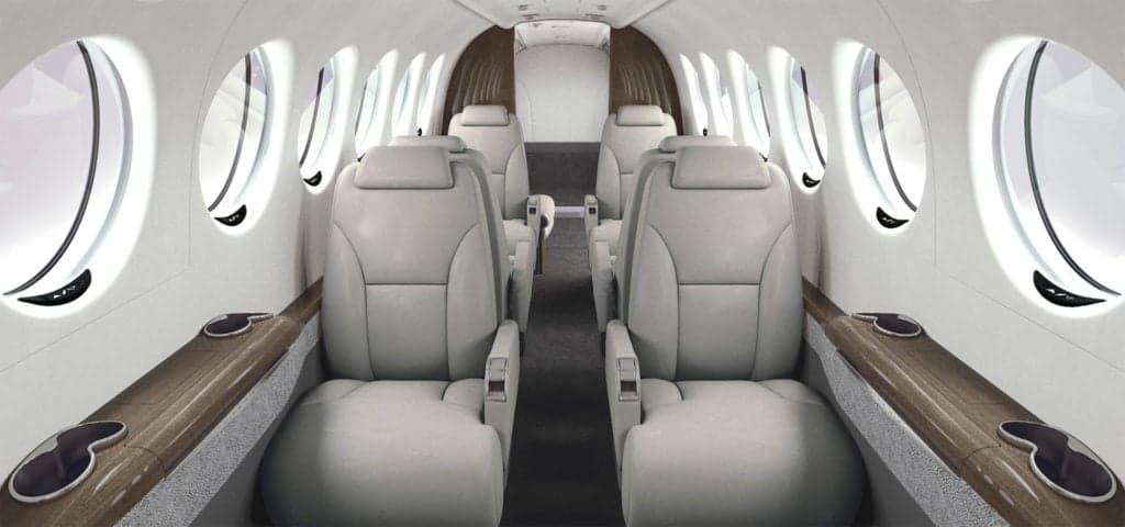 The interior of a King Air aircraft with leather seats and wood trim.