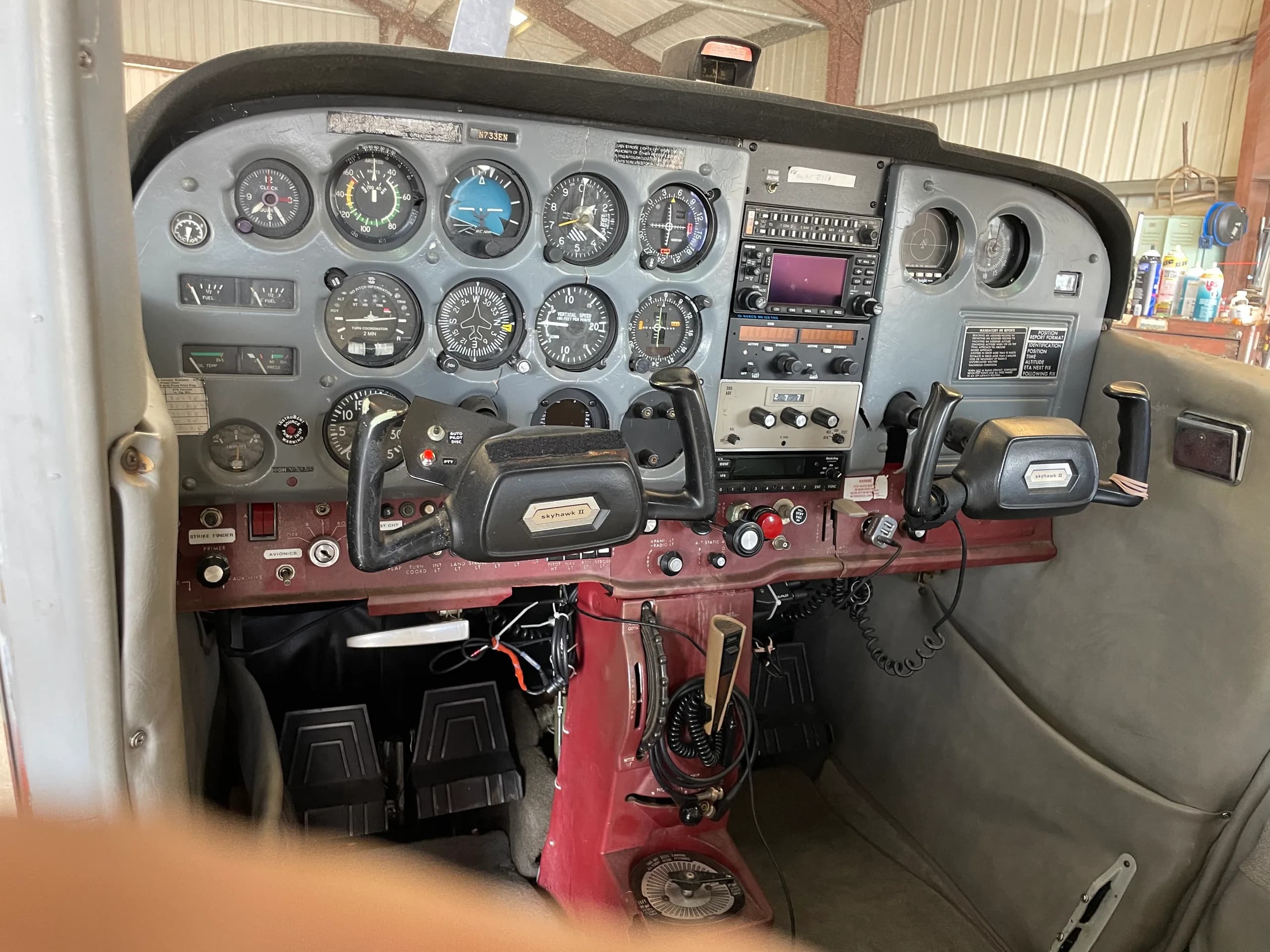 The instrument panel and controls of a Cessna 172, showing various gauges and avionics.