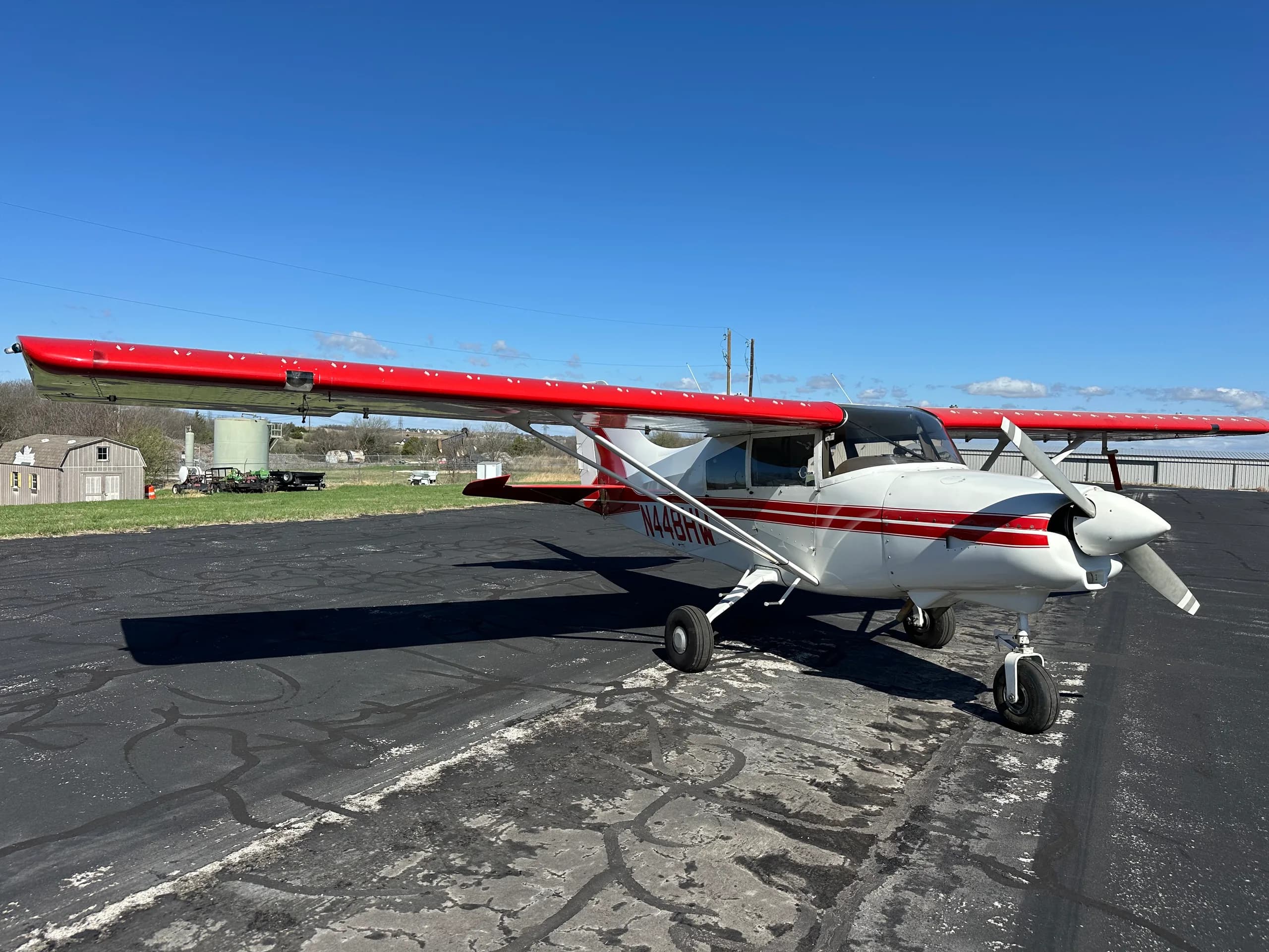 A Maute aircraft with red and white paint scheme is parked on the tarmac.