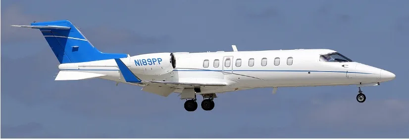 A Learjet 45XR with registration N189PP in flight with blue and white paint scheme.