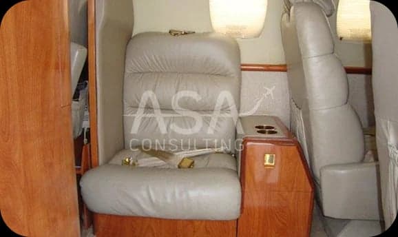 A single leather seat inside the aircraft cabin.