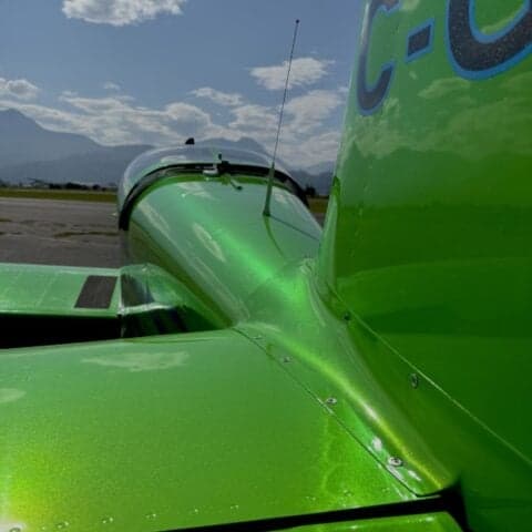 Close-up of the tail of a green aircraft with the registration C-GMC.