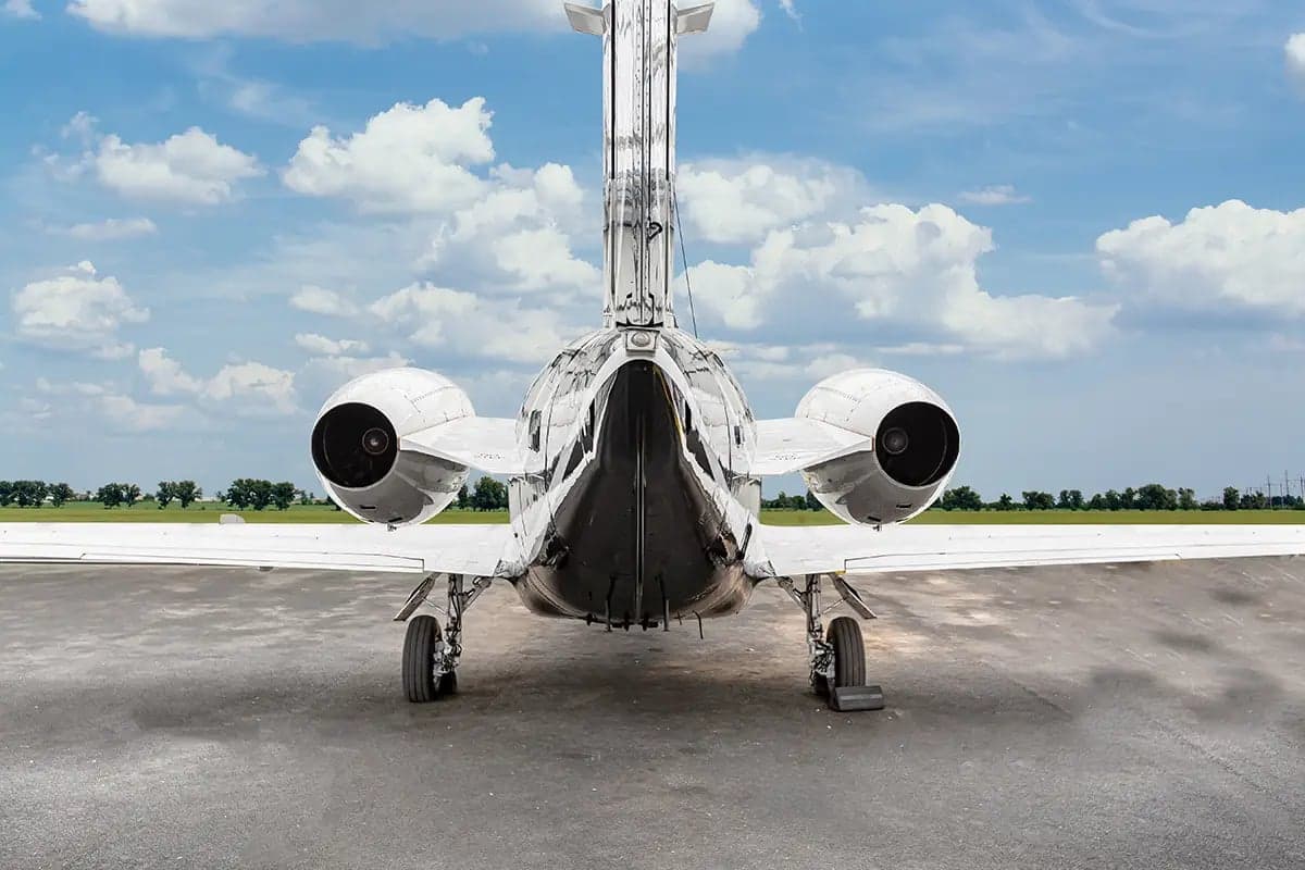 Rear view of the Nextant 400XT aircraft with registration OK-ESC showing the tail and engines.