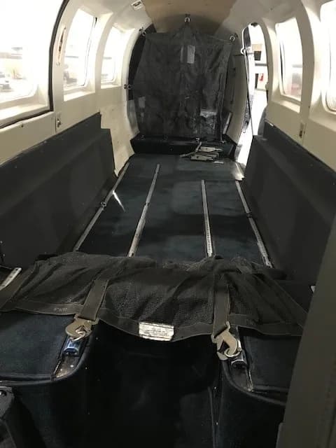 Empty aircraft interior with cargo netting.