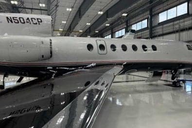 Side view of the N504CP aircraft in a hangar.