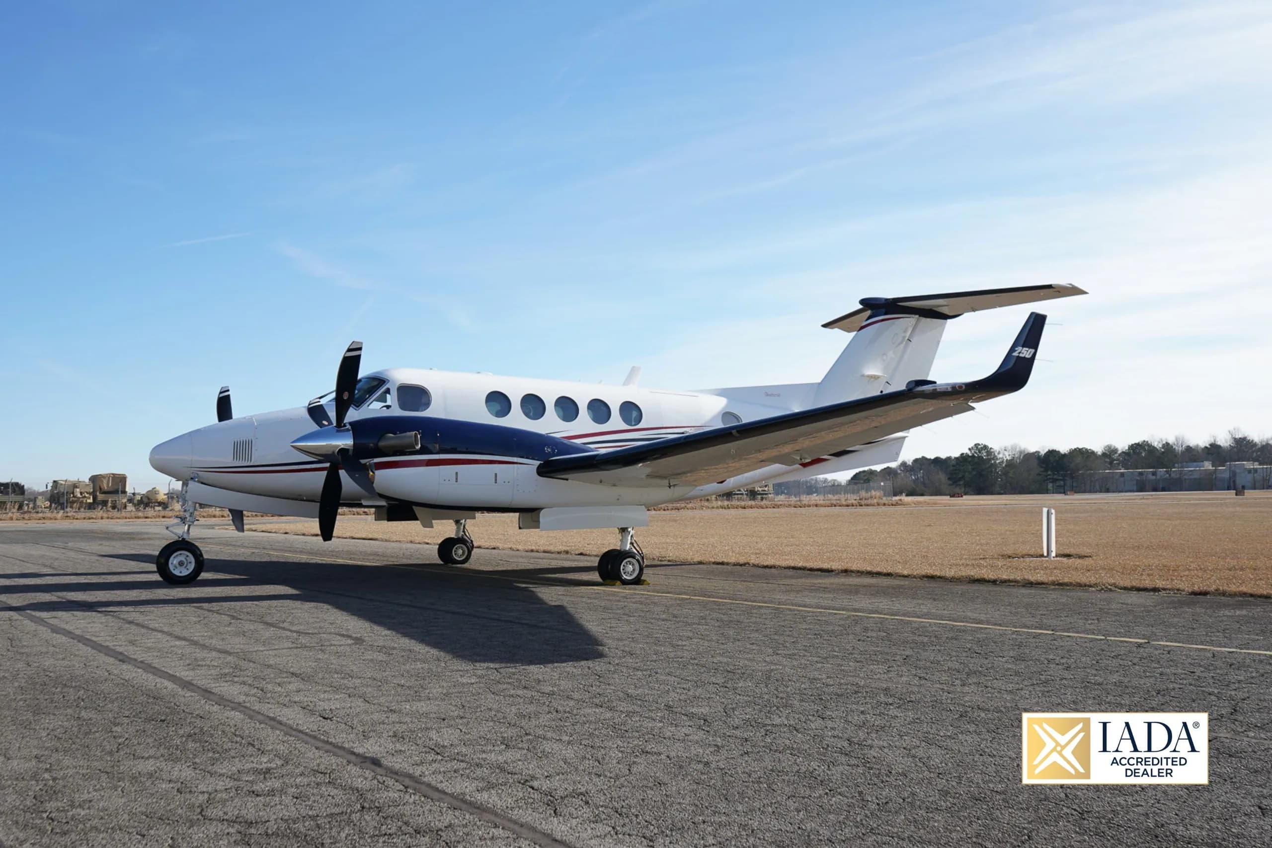 Beechcraft King Air 250 on the tarmac with a blue sky background.