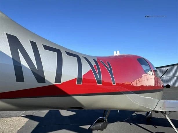 Close-up of the tail section of the LX7 aircraft N77VY.