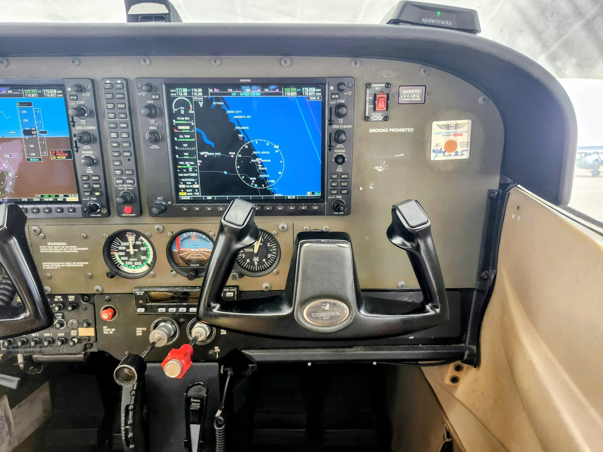 The right side of a Cessna Skyhawk SP cockpit shows the co-pilot's yoke and a Garmin G1000 display.