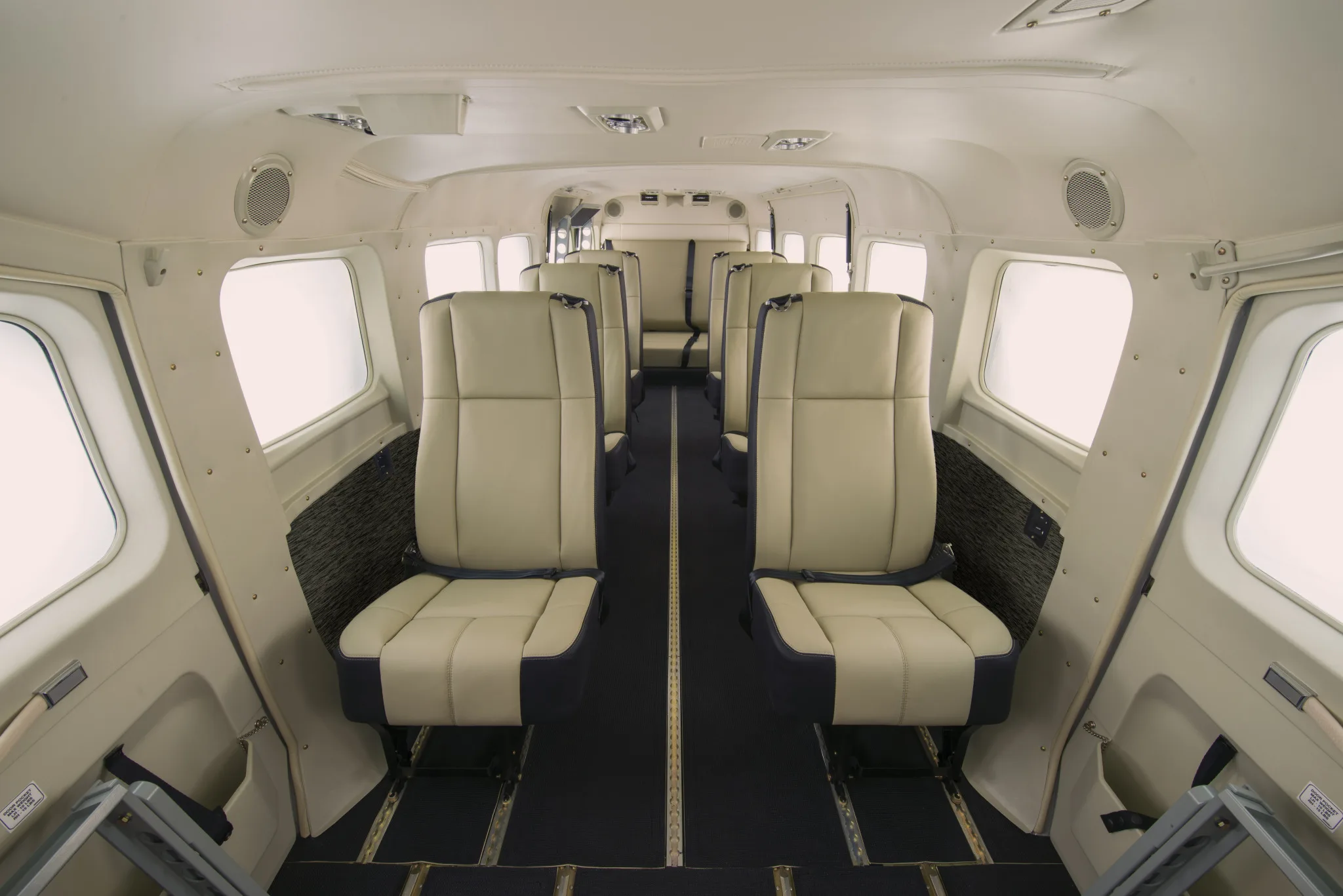 Cabin interior of a Cessna Grand Caravan with light colored seats.