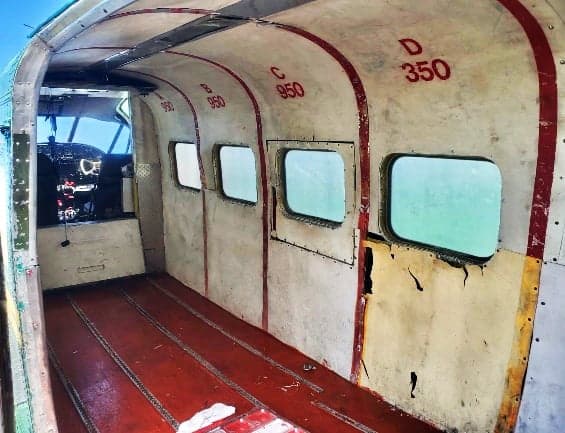 The interior of the Lockheed Model 10 Electra shows the cabin with windows and structural elements.