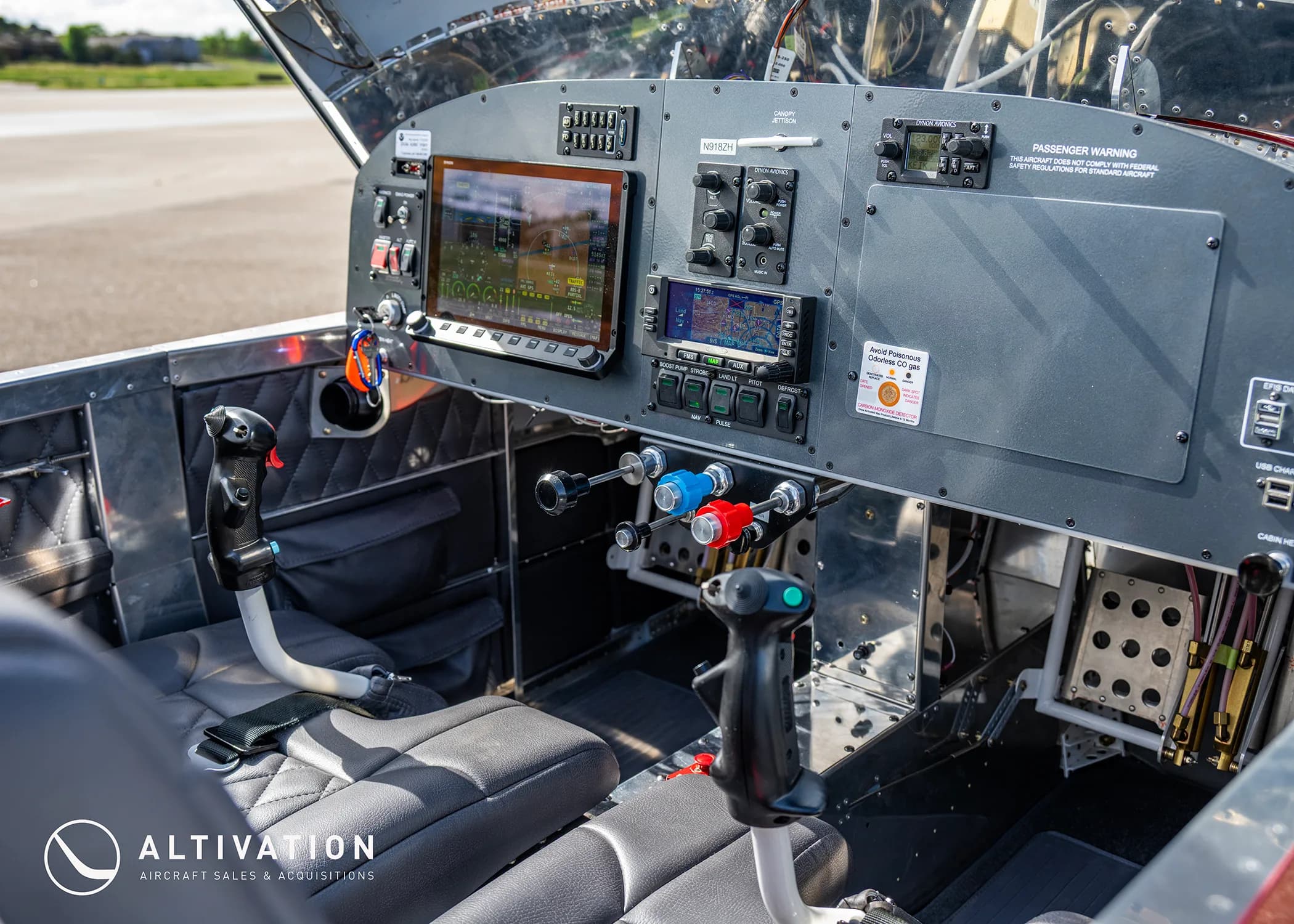 A wide view of the experimental aircraft's cockpit, featuring modern avionics, dual stick controls, and quilted seats.