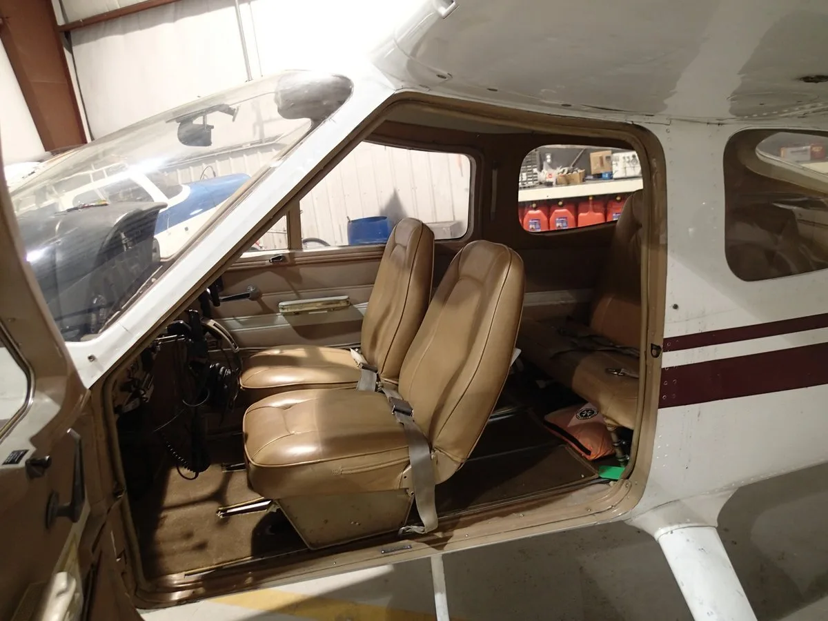 Interior view of the Cessna 177 Cardinal cabin, showing the seats and side panel.