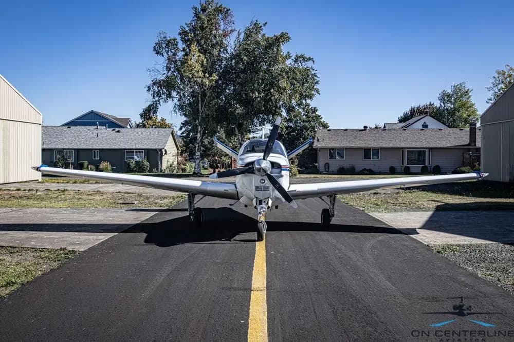 Front view of the Beechcraft Bonanza on the tarmac, facing the camera.
