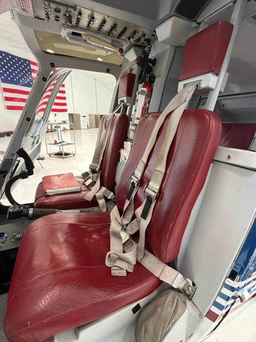 The cockpit of a Bell 206B JetRanger helicopter, showing the seats and instrument panel.
