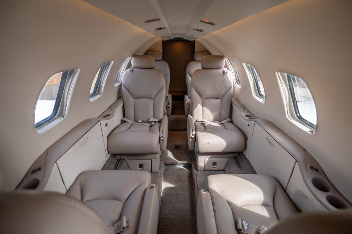 The interior of the aircraft features leather seats and a spacious cabin.
