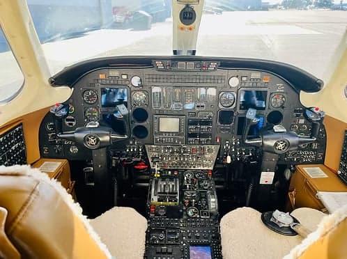View of the aircraft cockpit with instrument panel and controls.